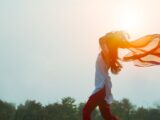 woman spreading hair at during sunset